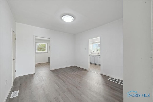1155 Pinewood Ave, Toledo, OH 43607 - empty room with wood finished floors and baseboards