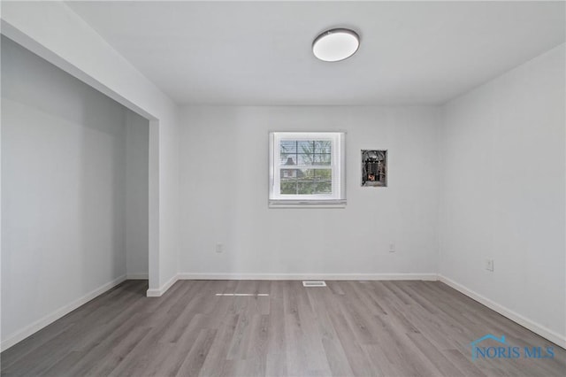 1155 Pinewood Ave, Toledo, OH 43607 - empty room featuring wood finished floors and baseboards