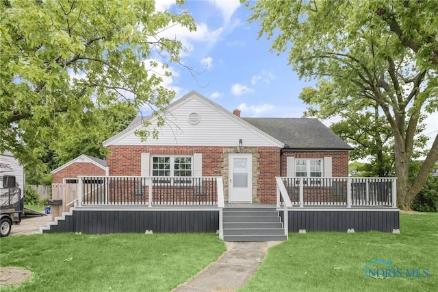 1421 Hurd Ave, Findlay, OH 45840 - bungalow with brick siding, a front lawn, a deck, and a chimney