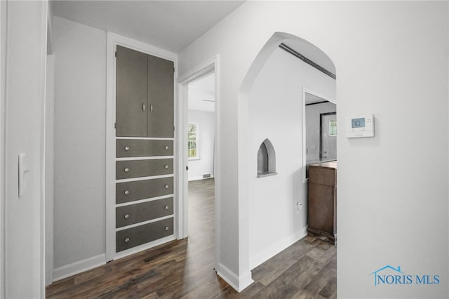 1421 Hurd Ave, Findlay, OH 45840 - hall with arched walkways and dark wood-type flooring