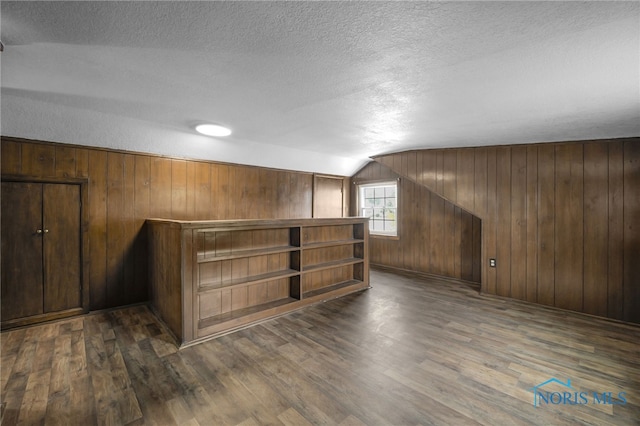 1421 Hurd Ave, Findlay, OH 45840 - bar featuring lofted ceiling, wood finished floors, a textured ceiling, and wood walls