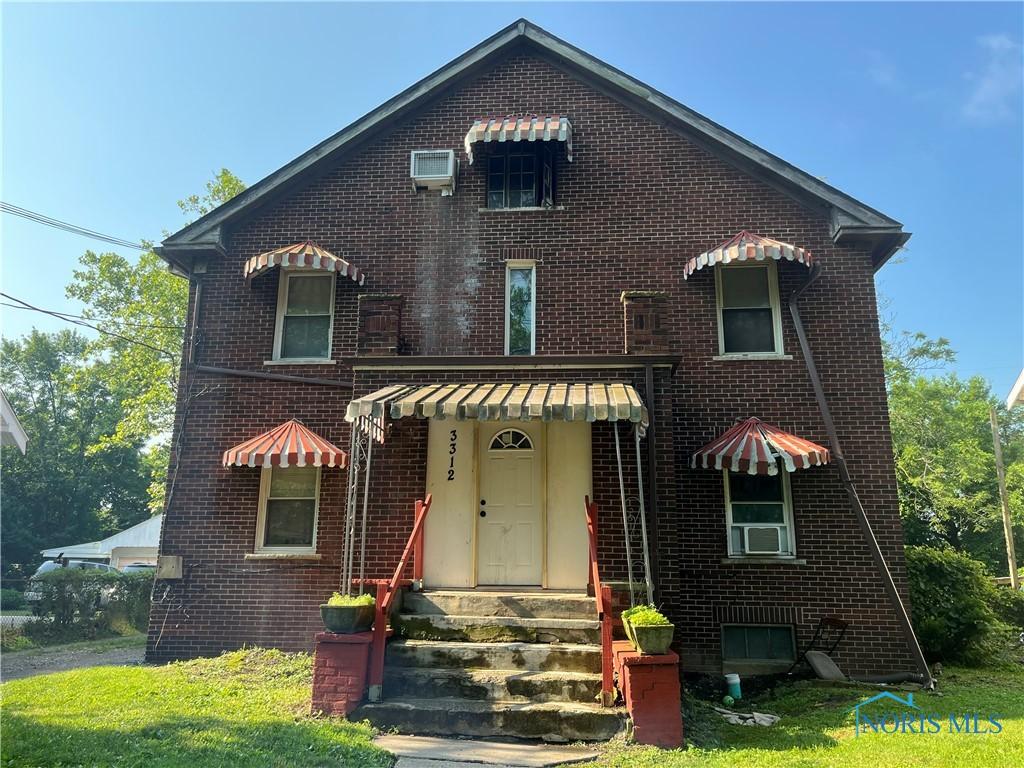 3312 E Manhattan Blvd, Toledo, OH 43611 - view of front of home with entry steps, brick siding, and cooling unit