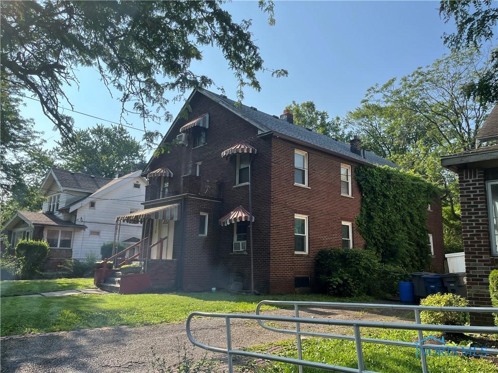 3312 E Manhattan Blvd, Toledo, OH 43611 - view of side of home featuring brick siding and a chimney
