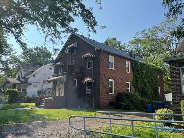 3312 E Manhattan Blvd, Toledo, OH 43611 - view of side of home featuring brick siding and a chimney