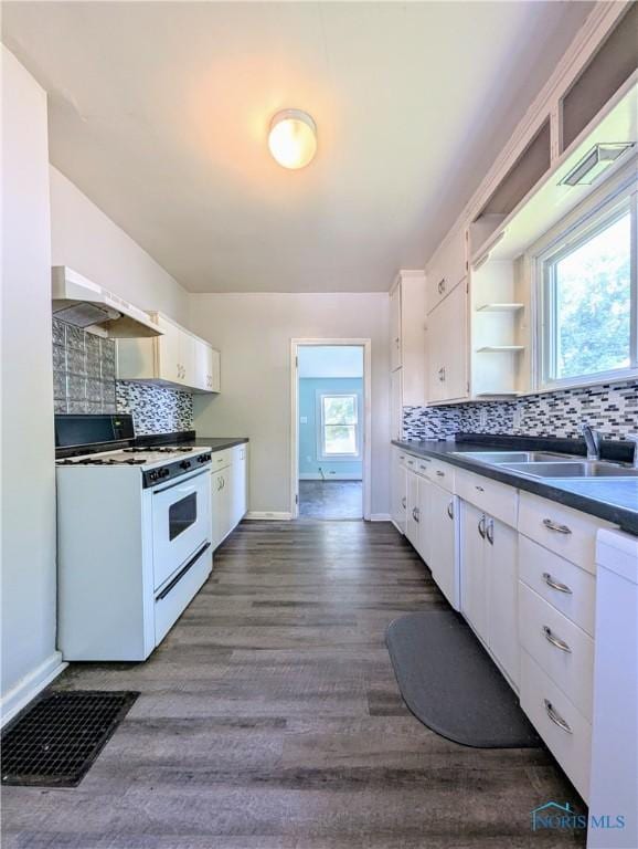 312 S Elm St, Pioneer, OH 43554 - kitchen featuring white appliances, range hood, open shelves, white cabinets, and dark countertops