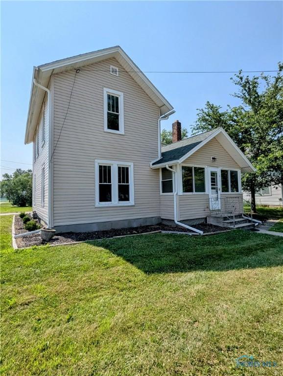 312 S Elm St, Pioneer, OH 43554 - back of house featuring a yard