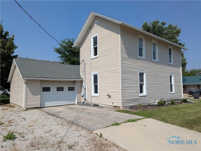 312 S Elm St, Pioneer, OH 43554 - view of side of property with driveway and a garage