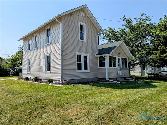312 S Elm St, Pioneer, OH 43554 - rear view of house featuring a lawn