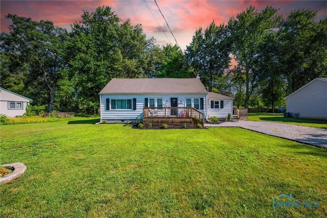 6006 Blossman Rd, Toledo, OH 43617 - view of front of home featuring a deck, a front yard, and crawl space