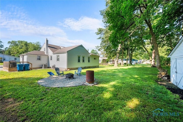 6006 Blossman Rd, Toledo, OH 43617 - view of grassy yard featuring a fire pit