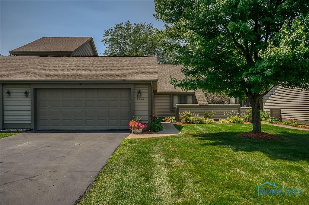 3008 Pleasant Hill Rd Unit 3008, Maumee, OH 43537 - view of front of property with asphalt driveway, an attached garage, a front lawn, and roof with shingles