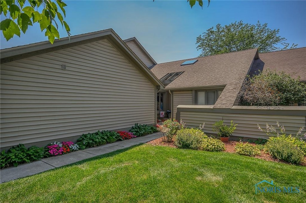 3008 Pleasant Hill Rd Unit 3008, Maumee, OH 43537 - view of home's exterior featuring a lawn and roof with shingles
