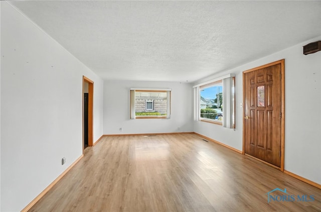 719 S Shannon St, Van Wert, OH 45891 - entryway with light wood-style flooring and a textured ceiling