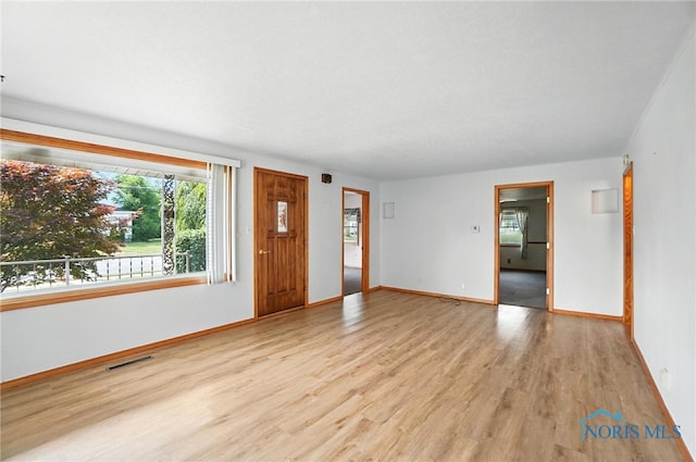 719 S Shannon St, Van Wert, OH 45891 - unfurnished living room with wood finished floors and baseboards