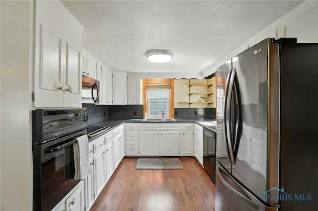 719 S Shannon St, Van Wert, OH 45891 - kitchen featuring black appliances, dark countertops, white cabinets, open shelves, and dark wood-style floors