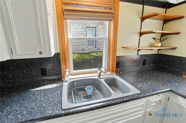 719 S Shannon St, Van Wert, OH 45891 - kitchen with open shelves, dark countertops, white cabinets, and healthy amount of natural light