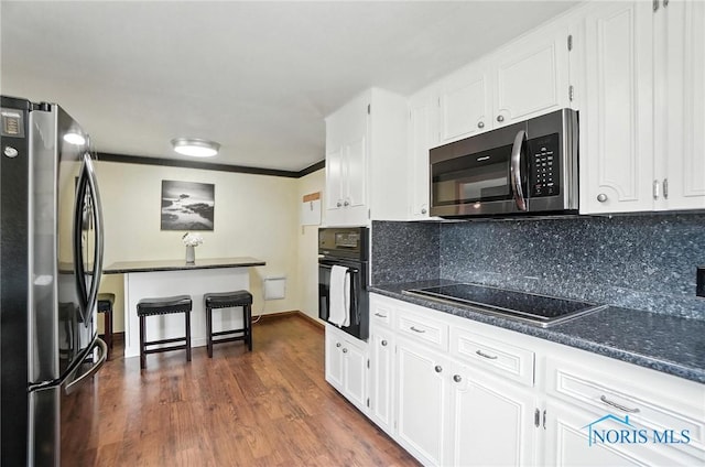719 S Shannon St, Van Wert, OH 45891 - kitchen featuring black appliances, white cabinets, decorative backsplash, dark wood finished floors, and crown molding