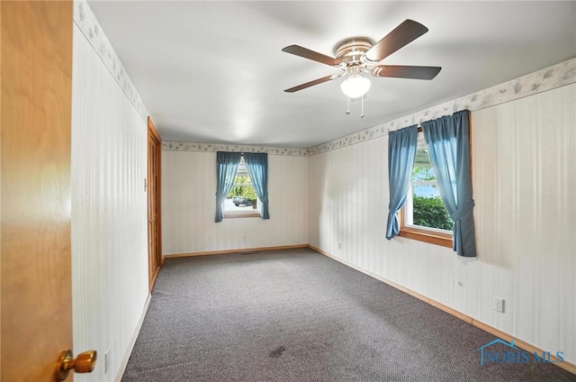 719 S Shannon St, Van Wert, OH 45891 - carpeted empty room with wallpapered walls and a ceiling fan