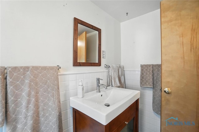 719 S Shannon St, Van Wert, OH 45891 - bathroom featuring vanity, tile walls, and wainscoting