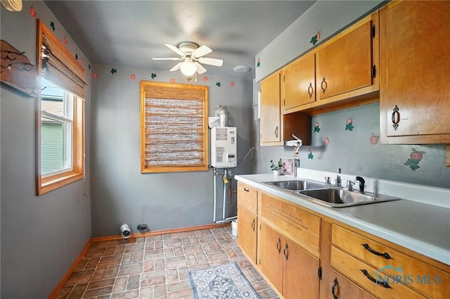 719 S Shannon St, Van Wert, OH 45891 - kitchen featuring ceiling fan, light countertops, brick patterned flooring, and water heater