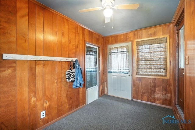 719 S Shannon St, Van Wert, OH 45891 - carpeted entrance foyer featuring wood walls, plenty of natural light, a ceiling fan, and crown molding