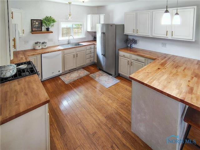 15740 Hill Rd, Defiance, OH 43512 - kitchen with butcher block counters, white dishwasher, high end refrigerator, and pendant lighting
