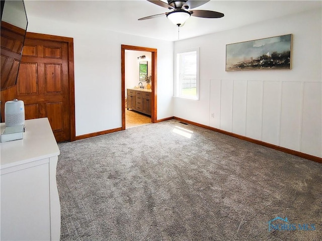 15740 Hill Rd, Defiance, OH 43512 - unfurnished bedroom with light carpet, connected bathroom, and a ceiling fan