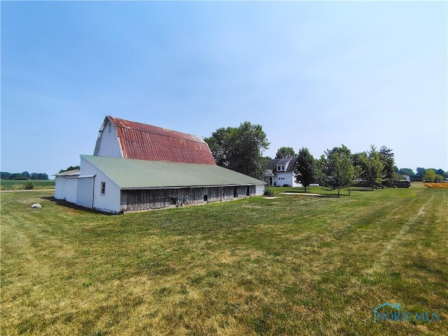 15740 Hill Rd, Defiance, OH 43512 - view of property exterior with a yard, an outdoor structure, a gambrel roof, a barn, and a metal roof