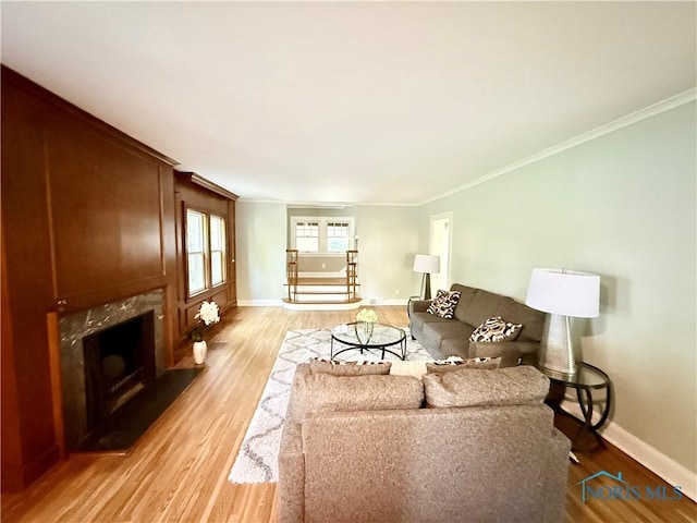 2515 Densmore Dr, Toledo, OH 43606 - living area with light wood-style flooring, ornamental molding, and a fireplace
