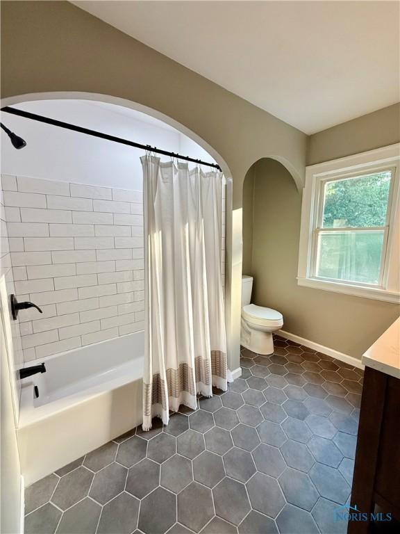 2515 Densmore Dr, Toledo, OH 43606 - full bath with vanity, shower / bathtub combination with curtain, and tile patterned flooring