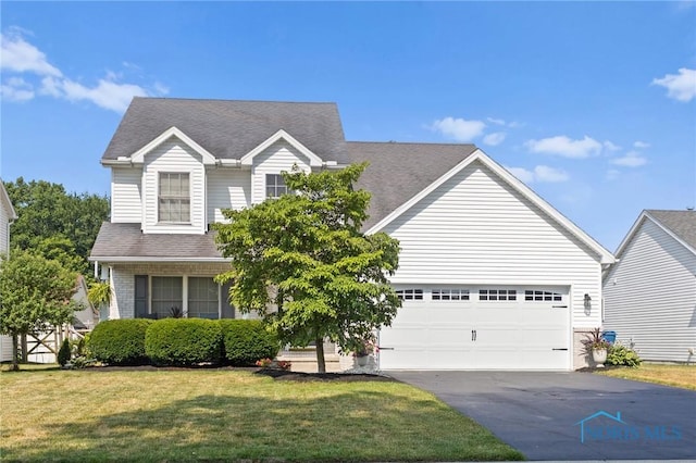 606 Niagara Ave, Holland, OH 43528 - traditional-style home featuring driveway, a front yard, an attached garage, and roof with shingles