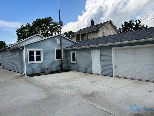 203 S Main, Hicksville, OH 43526 - rear view of property with an attached garage and concrete driveway