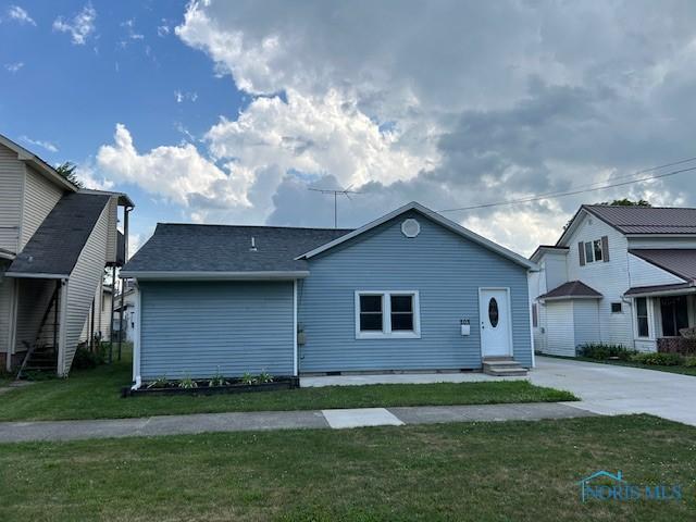 203 S Main, Hicksville, OH 43526 - view of front of house featuring entry steps, crawl space, a front lawn, and driveway