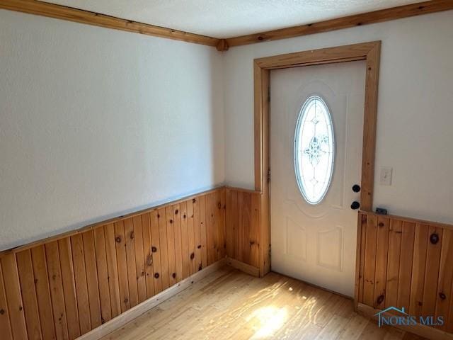 203 S Main, Hicksville, OH 43526 - foyer with a wainscoted wall, light wood-style flooring, and wooden walls