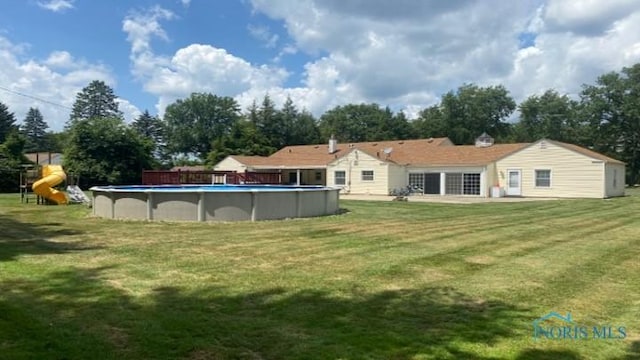 1036 Saint Andrews Rd, Toledo, OH 43607 - rear view of property with a lawn and an outdoor pool