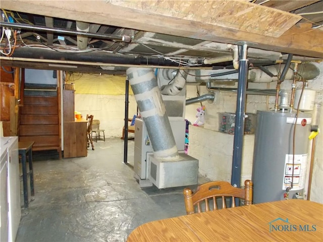 431 Fillmore St, Napoleon, OH 43545 - unfinished basement with gas water heater, stairway, heating unit, and washer / dryer