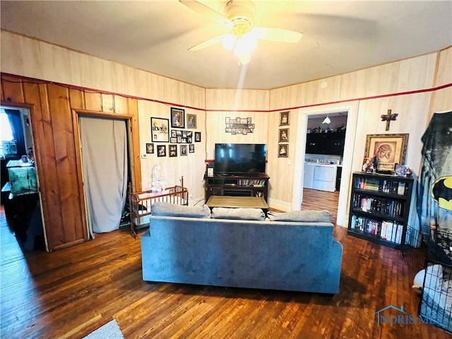 221 S 7th St, Upper Sandusky, OH 43351 - living room featuring washer and dryer, a ceiling fan, wood finished floors, and wooden walls
