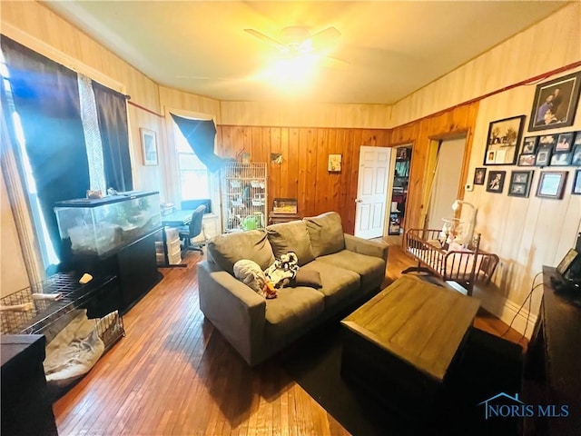 221 S 7th St, Upper Sandusky, OH 43351 - living room with ceiling fan, wood walls, and wood-type flooring