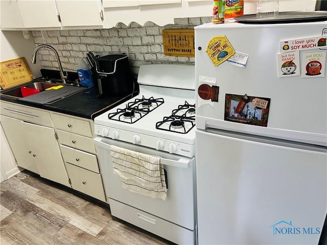 221 S 7th St, Upper Sandusky, OH 43351 - kitchen featuring white appliances, light wood finished floors, and white cabinets