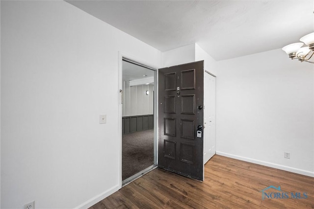 6201 Garden Rd Unit A14, Maumee, OH 43537 - empty room featuring dark wood-style floors and a chandelier