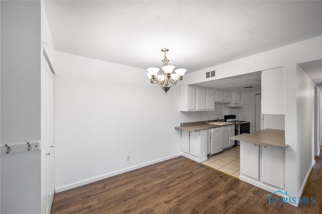 6201 Garden Rd Unit A14, Maumee, OH 43537 - kitchen with a chandelier, wood finished floors, electric range oven, and white dishwasher