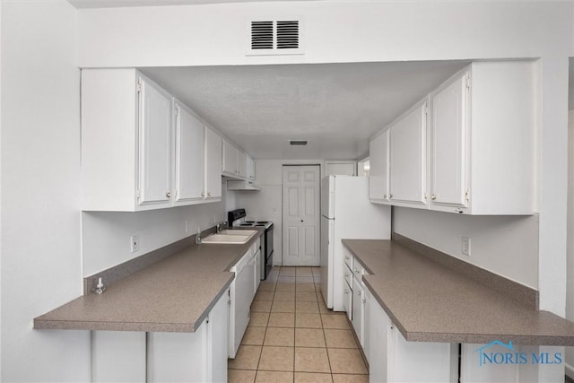 6201 Garden Rd Unit A14, Maumee, OH 43537 - kitchen with white cabinets, white appliances, and light tile patterned floors