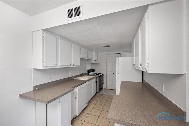 6201 Garden Rd Unit A14, Maumee, OH 43537 - kitchen with white appliances, white cabinets, under cabinet range hood, and light tile patterned floors