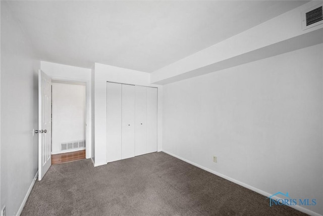 6201 Garden Rd Unit A14, Maumee, OH 43537 - unfurnished bedroom featuring dark carpet and a closet