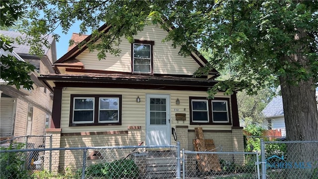 712 Forsythe St, Toledo, OH 43605 - view of front of property with a gate, brick siding, and a fenced front yard