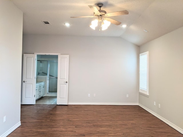 unfurnished room featuring dark hardwood / wood-style flooring, lofted ceiling, and ceiling fan