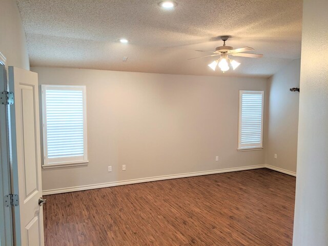 empty room with dark wood-type flooring, a textured ceiling, and ceiling fan