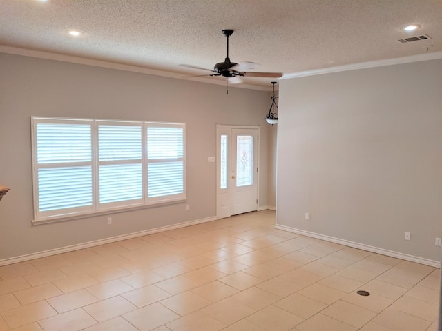 empty room with crown molding, ceiling fan, and a textured ceiling