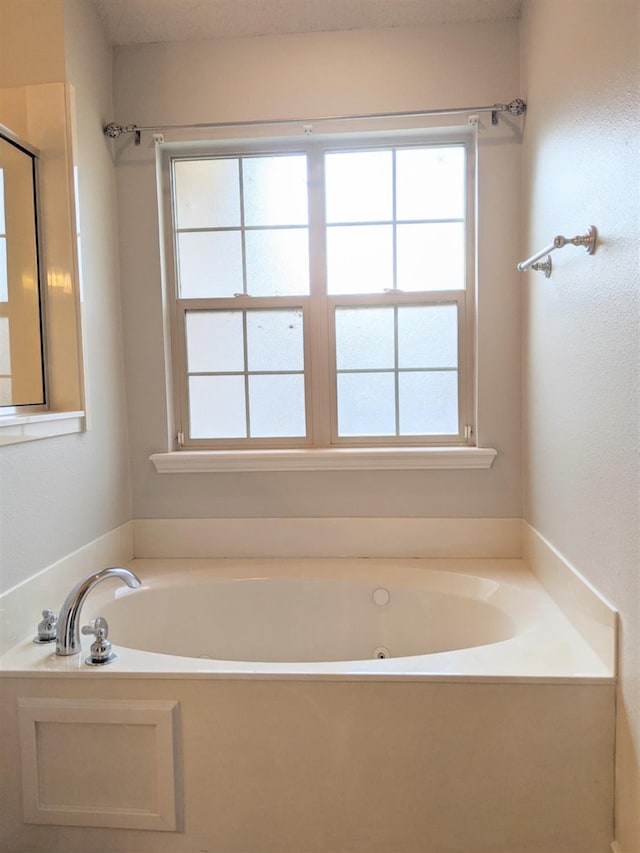 bathroom with a bathing tub and a wealth of natural light