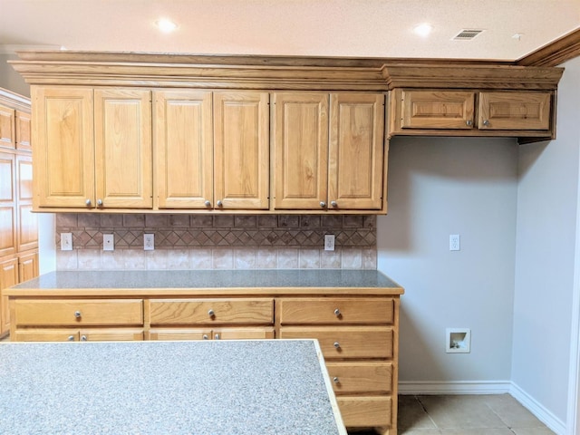 kitchen featuring backsplash and light tile patterned flooring